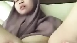 Precious Malaysian chick is lying on couch and fondling her big boobs