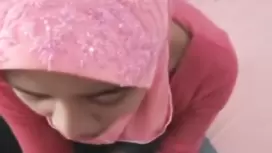 Malaysian young hooker wearing pink hijab is doing tight blowjob